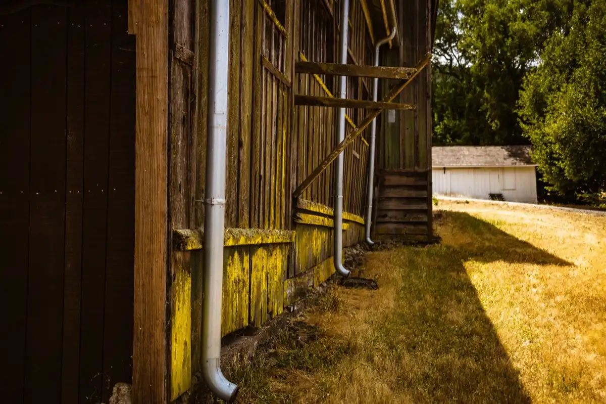 Roof edge, fascia and downspout on a house in Santa Fe, NM, where drip edge carries runoff into the gutter